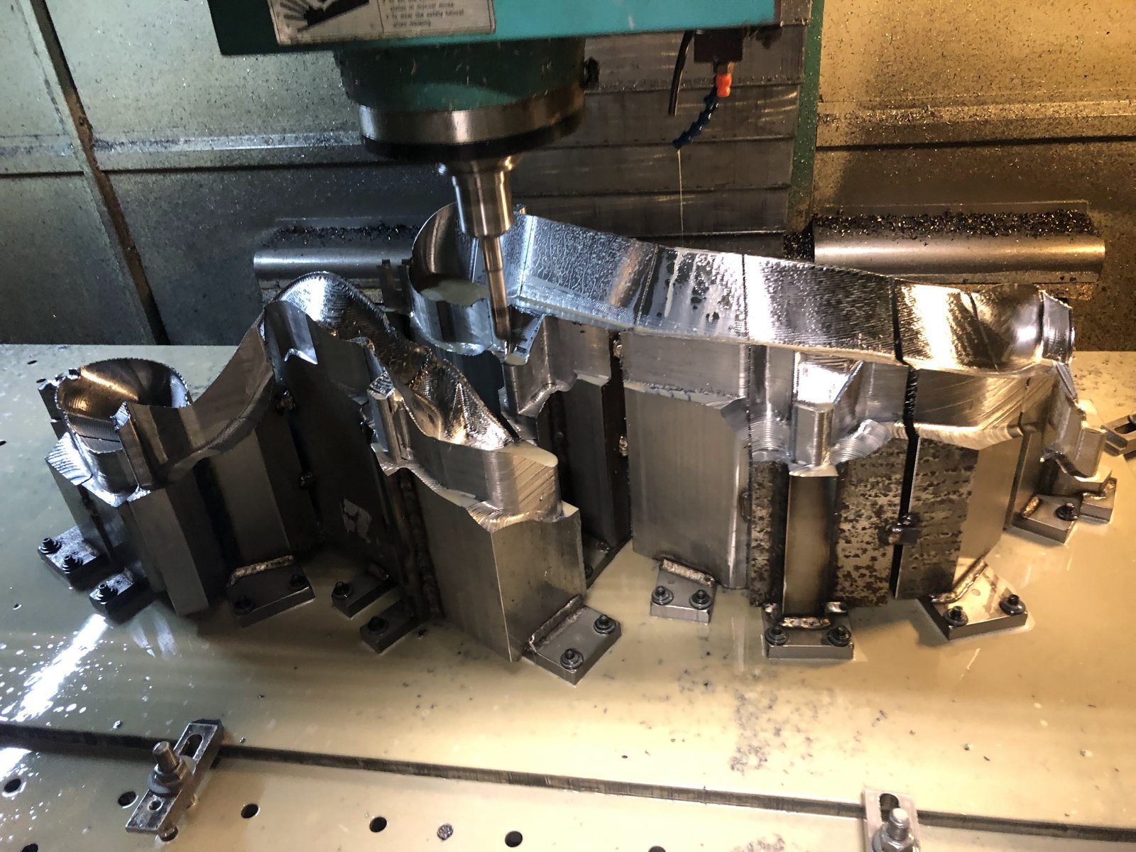 Cutter machining a contoured form on a large welded base
