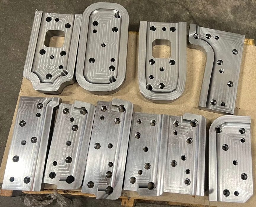 Services Batch of finished machined plates laid out on a pallet