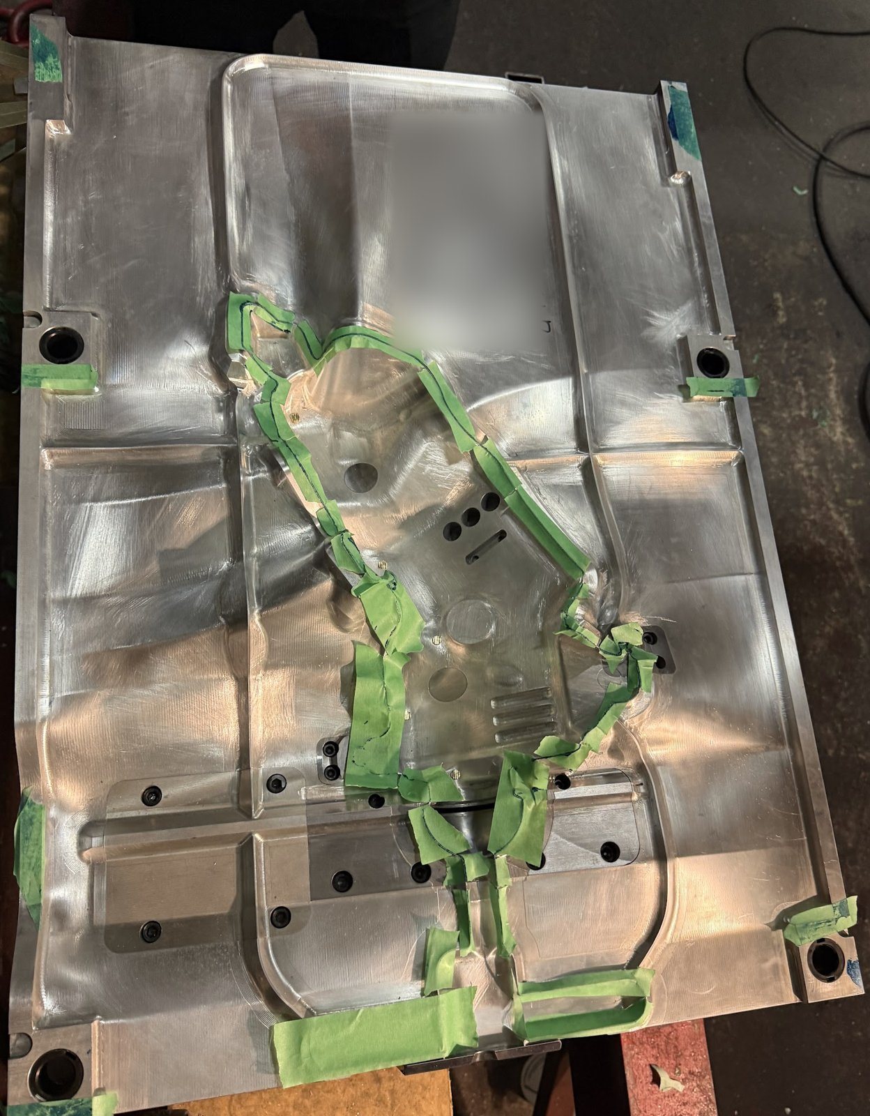 Large blow mould cavity with green tape along the spotted parting line
